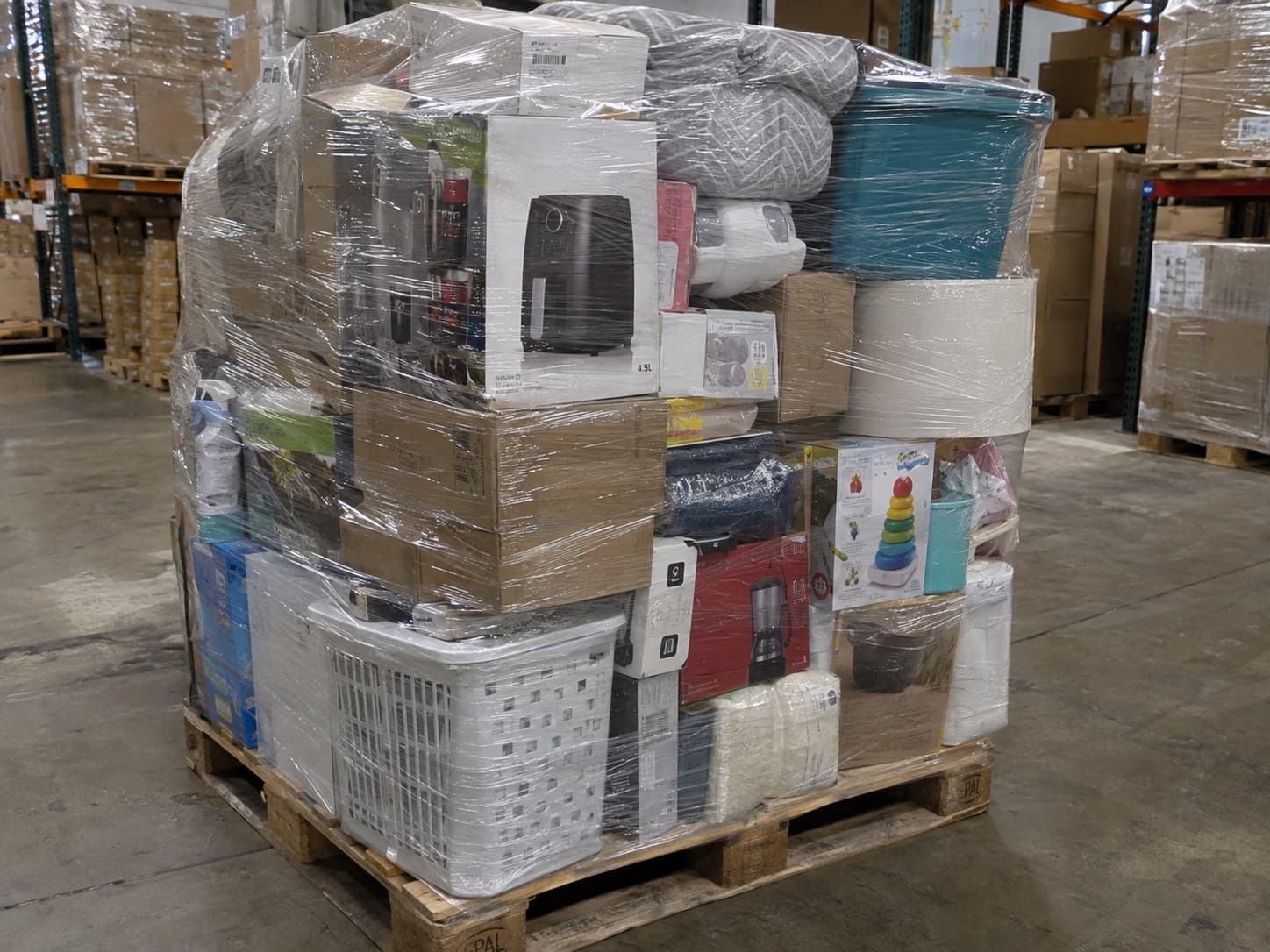 Pallet of mixed general merchandise including small appliances, bedding and storage items